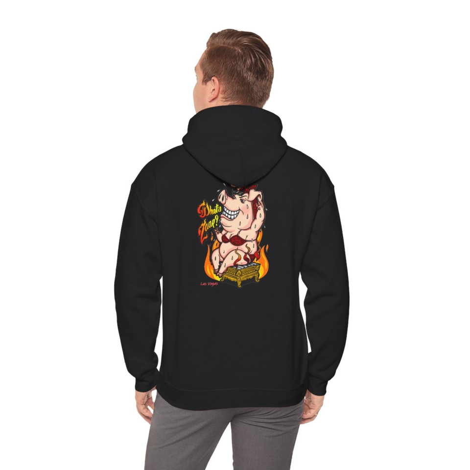 Person modeling a black hoodie from behind, featuring a colorful sweating cartoon pig sitting in flames with “That’s Zaaa!” text.